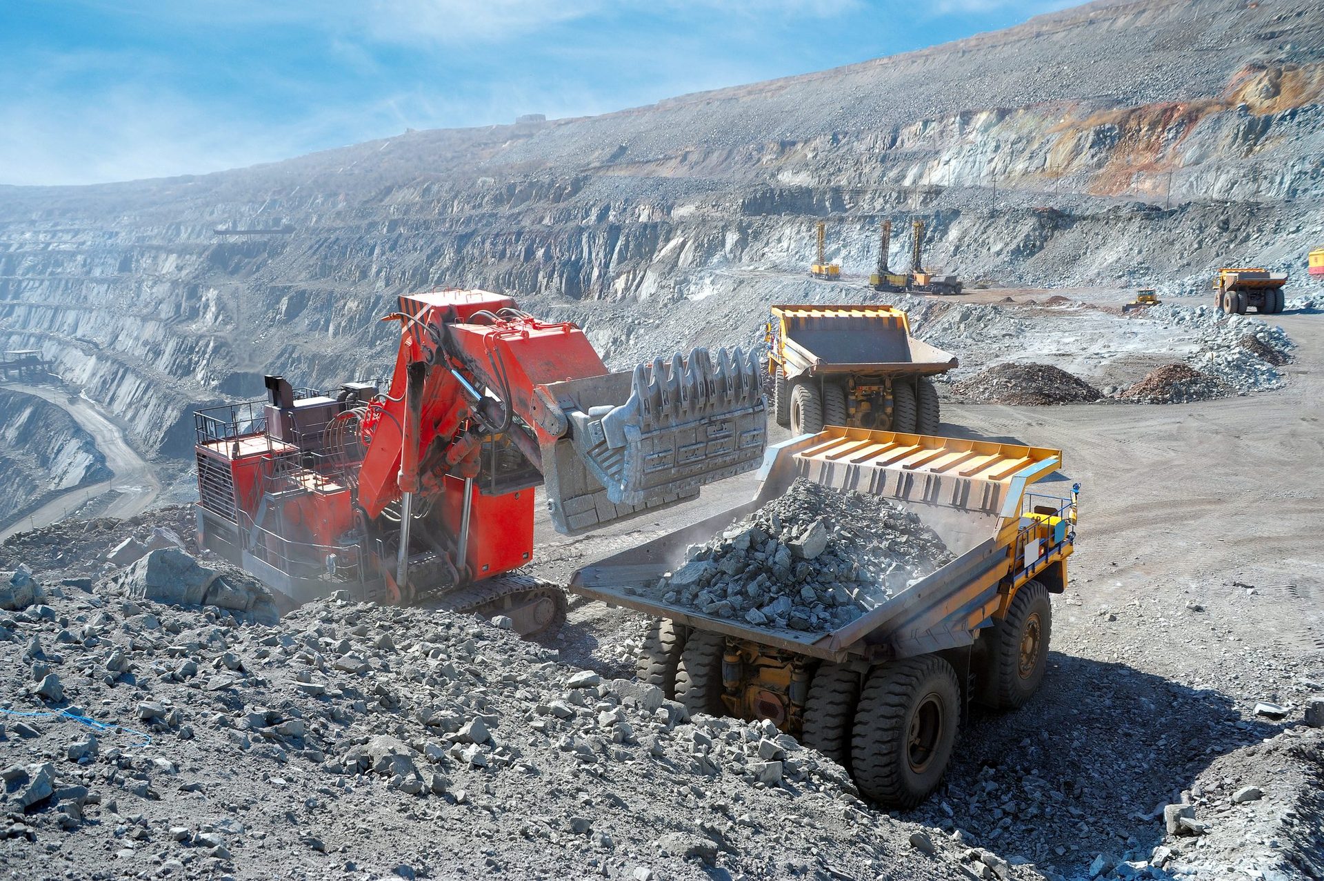 Excavator loading a haul truck at an open-pit mine